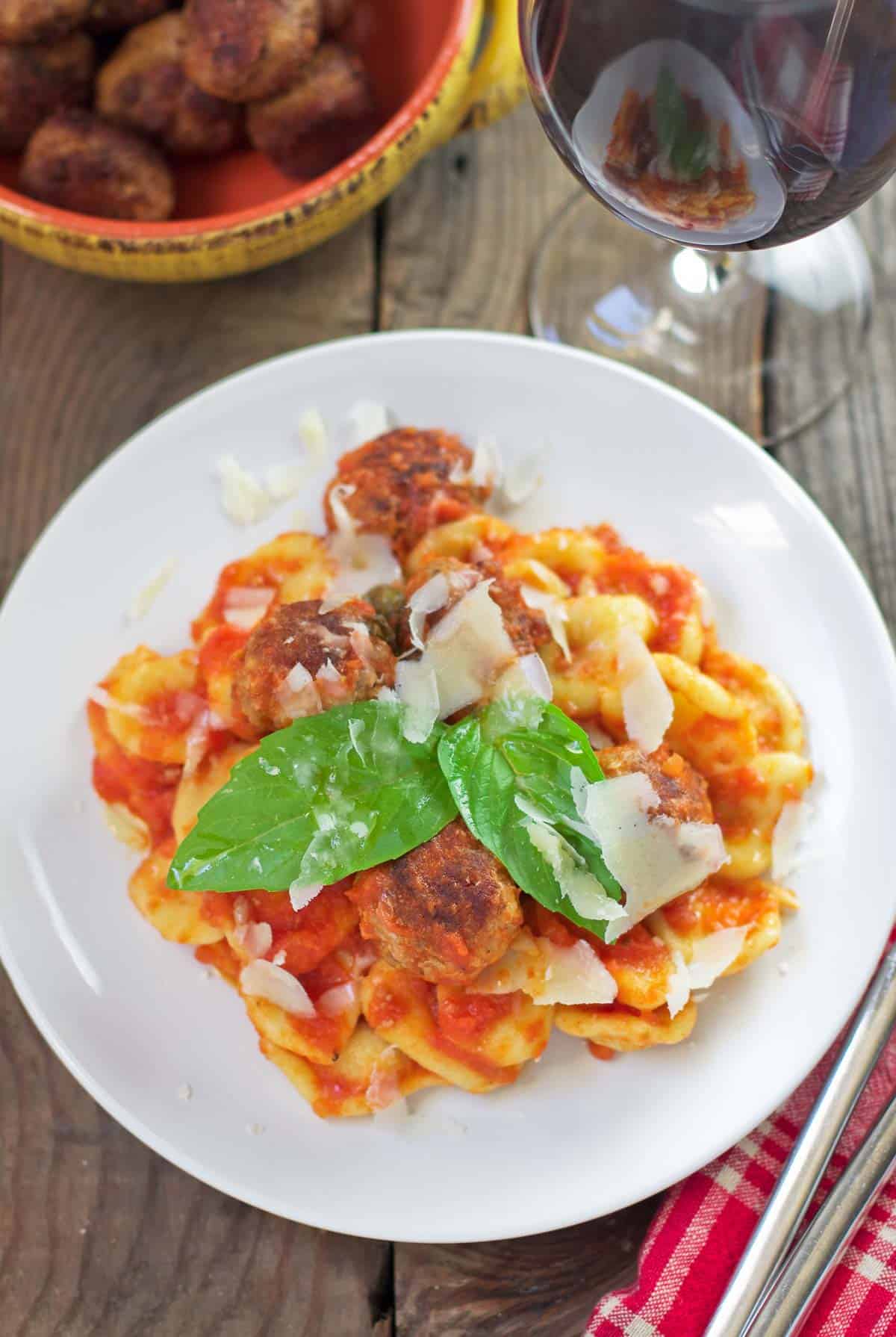 Homemade Orecchiette Pasta with meatballs and tomato sauce on a platter