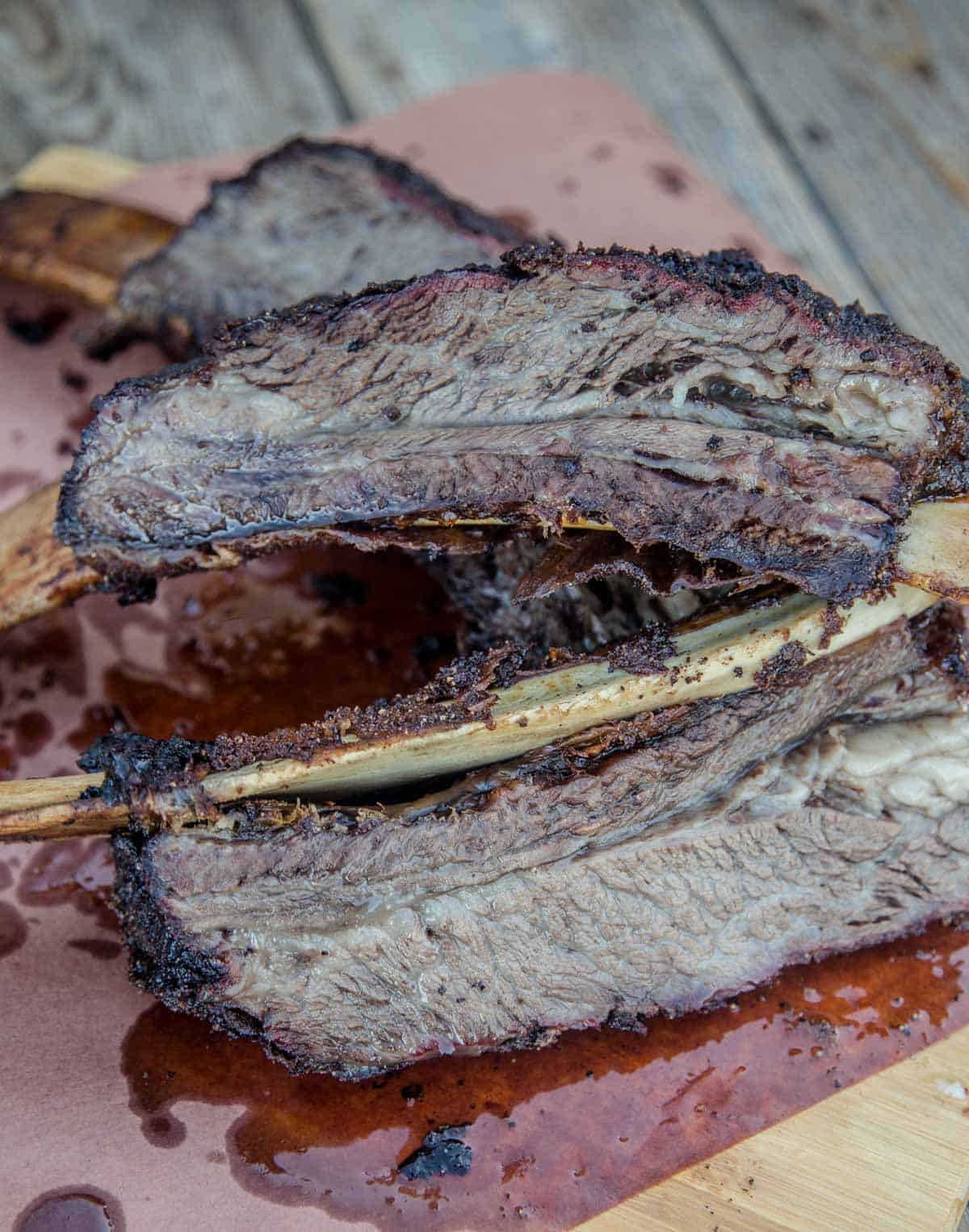 Smoked beef ribs, sliced, on butcher paper