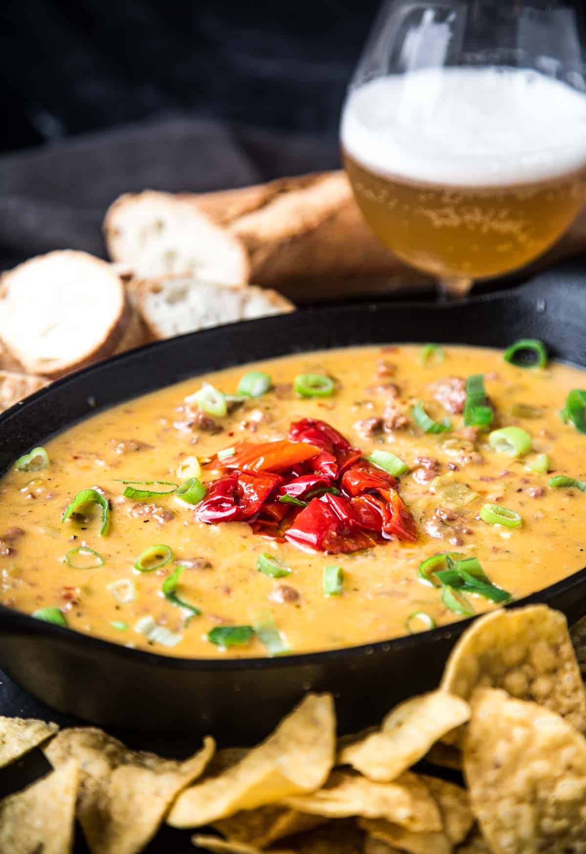 Smoked Beer Cheese Dip in a platter with a glass of beer