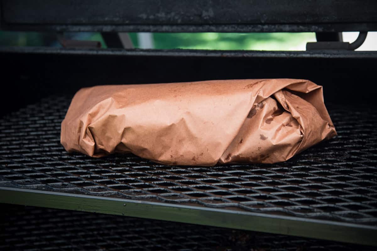 a full smoked brisket wrapped in pink butcher paper