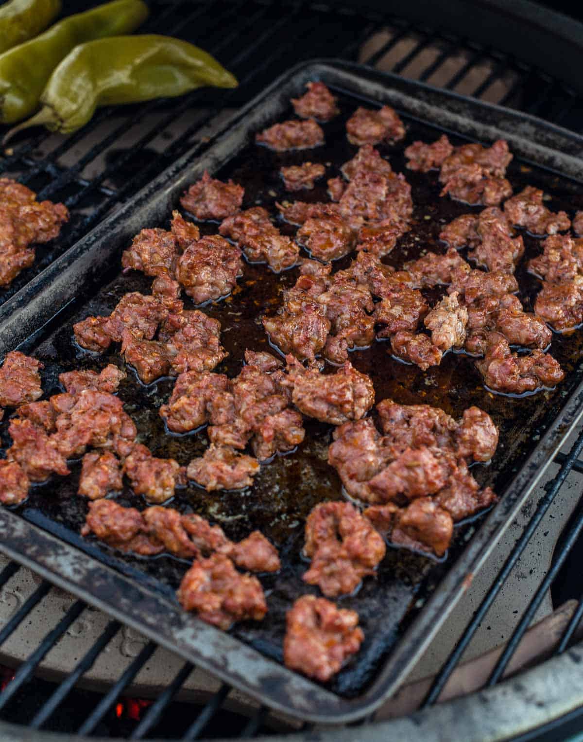 Smoked sausage on a baking sheet in the smoker