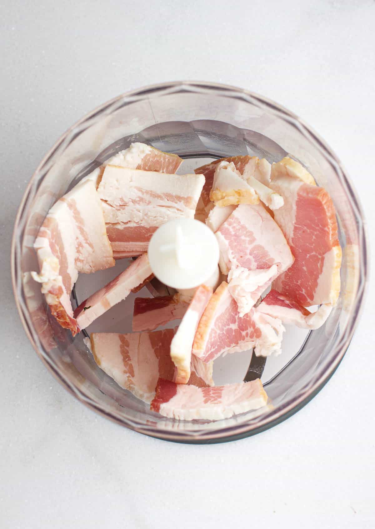 Chopped up raw bacon in a food processor.
