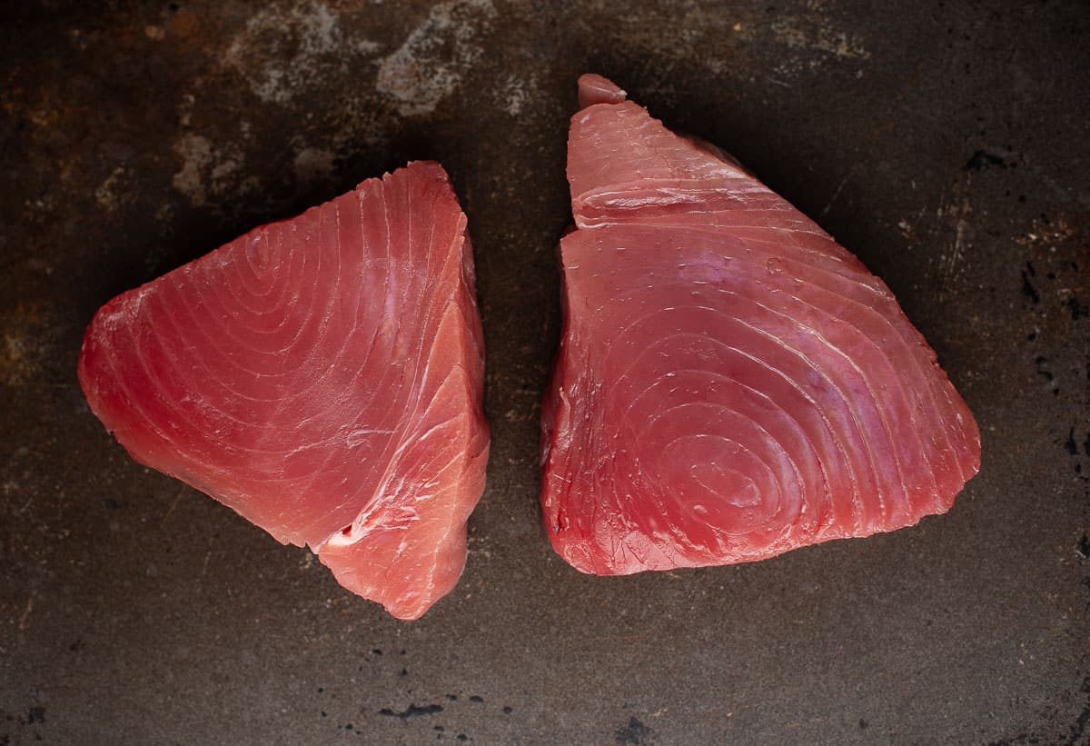 Two raw Ahi tuna steaks on a dish