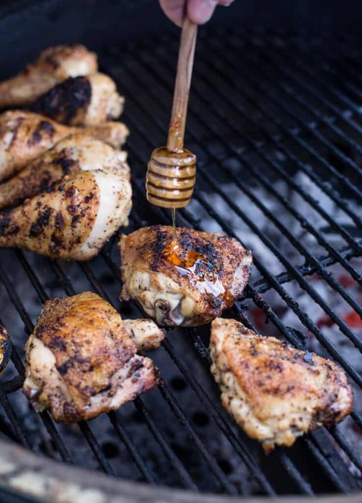 Glazing Grilled Chicken pieces with hot honey sauce.