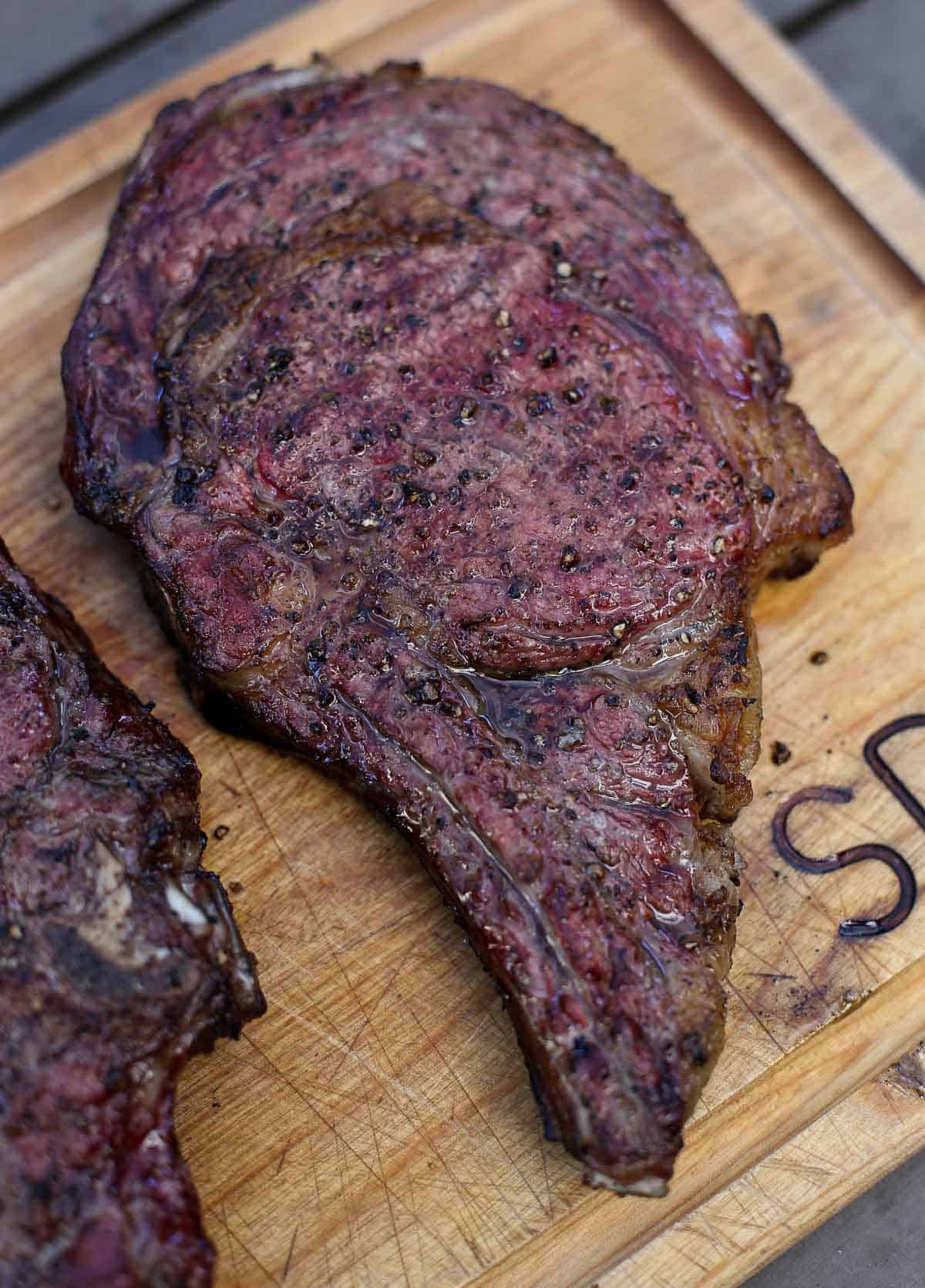 A Grilled Ribeye Steak on a wearing board