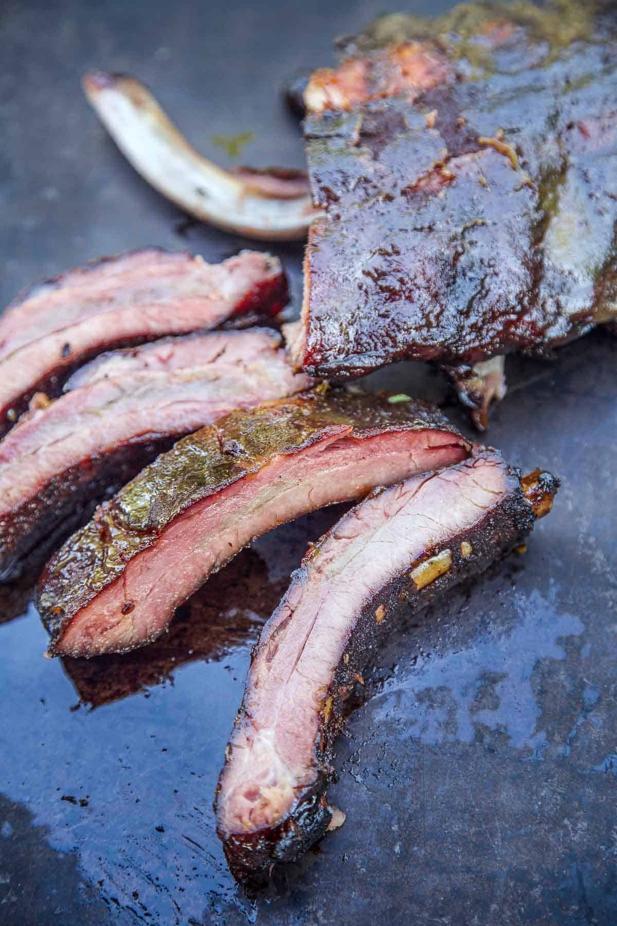 A rack of Smoked Honey Mustard Ribs on a serving platter