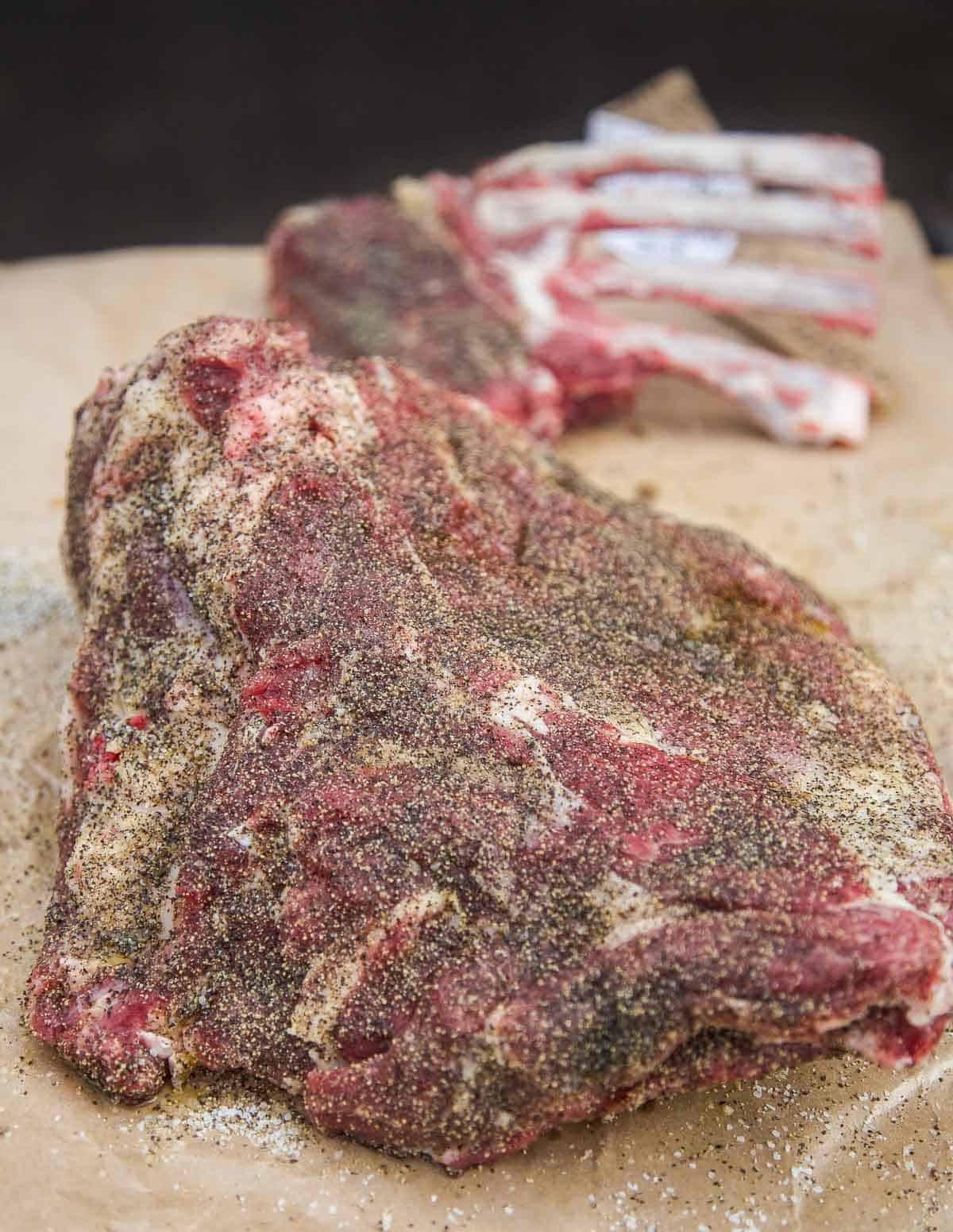 A raw lamb shoulder covered with lamb seasoning