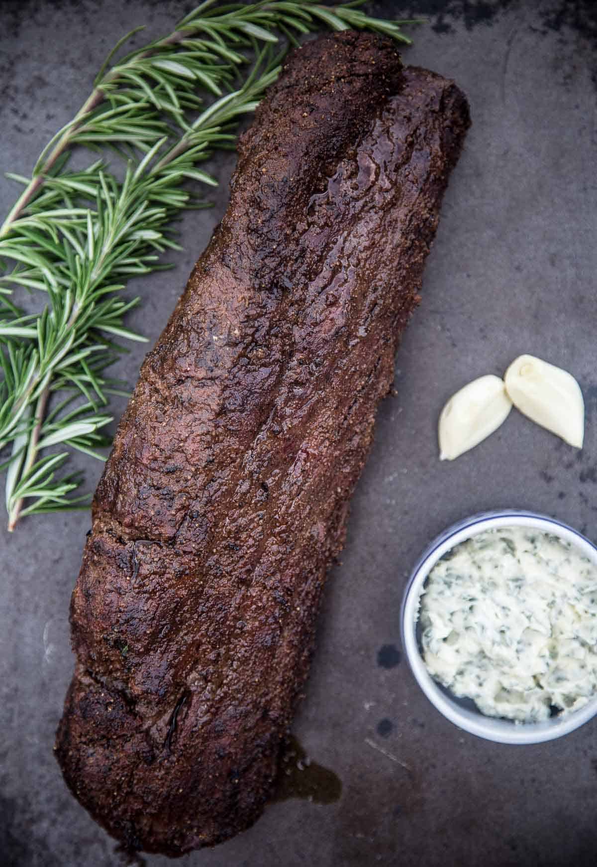 A Smoked Beef Tenderloin resting on a sheetpan