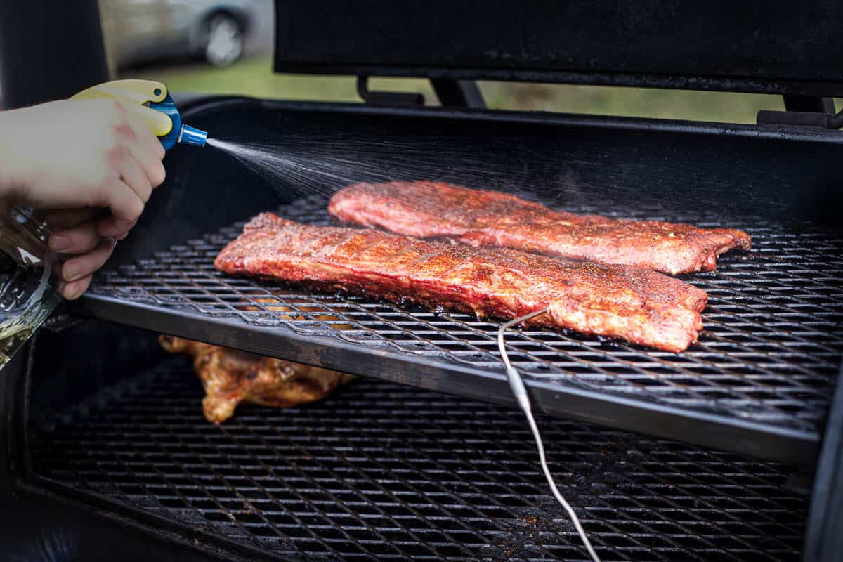 Spritzing Ribs on a smoker