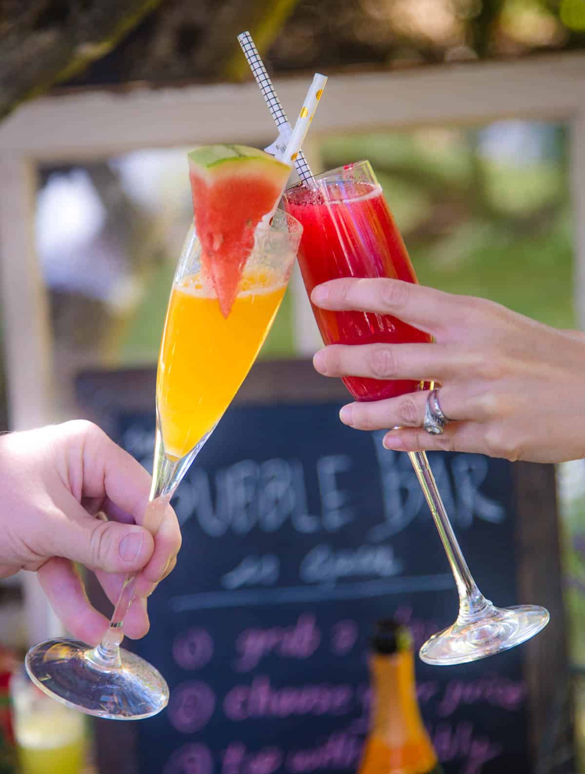 Two Mimosa glasses toasting one another