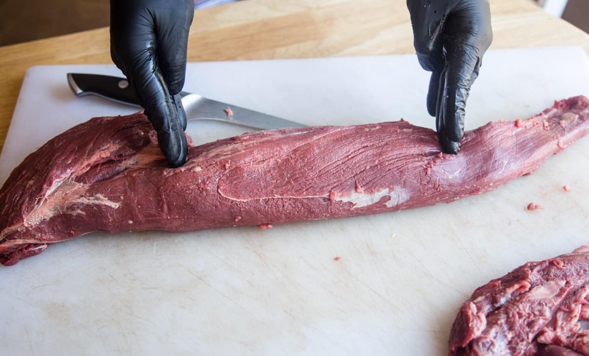 A full raw beef tenderloin about to be trimmed