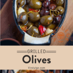 Baked olives in a grill on a cutting board.