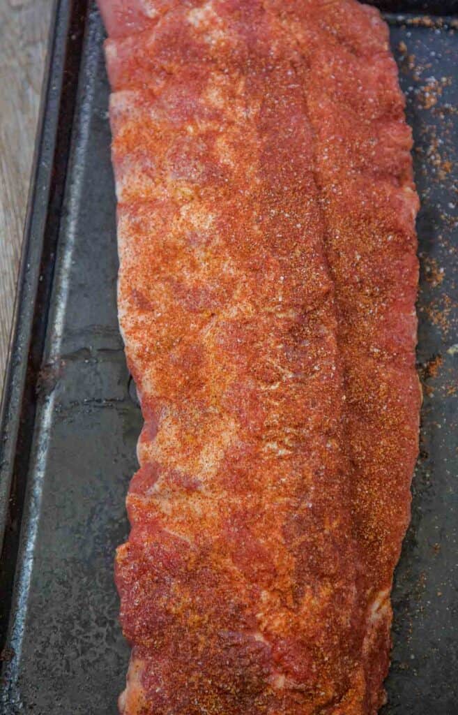 raw ribs seasoned with the ultimate dry rub for ribs