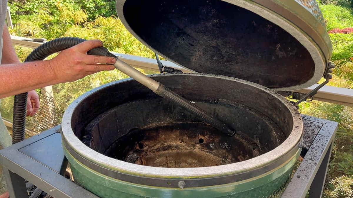 Cleaning ash from the Big Green Egg using a ash vacuum.