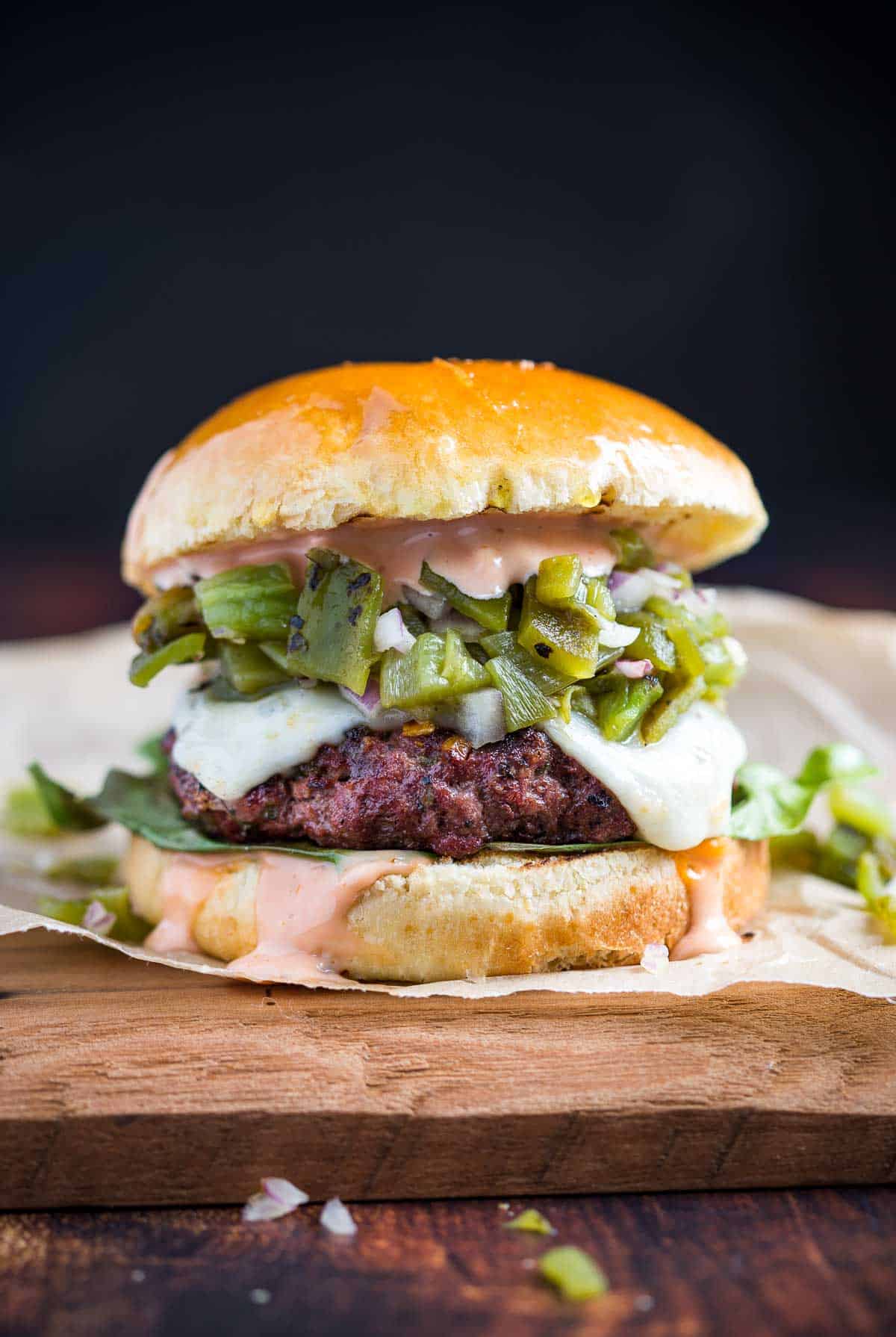 A Green Chile Cheeseburger on a serving dish