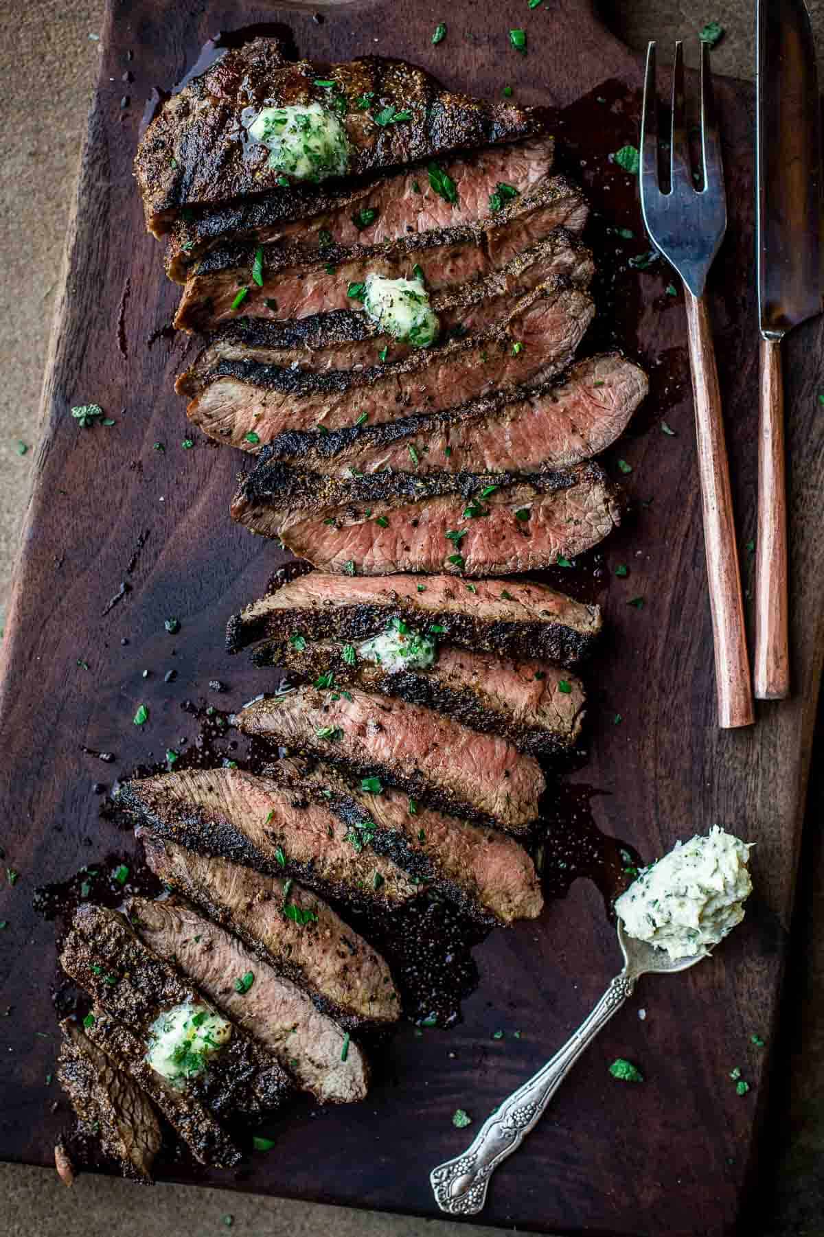 Slices of grilled beef topped with an herbed butter