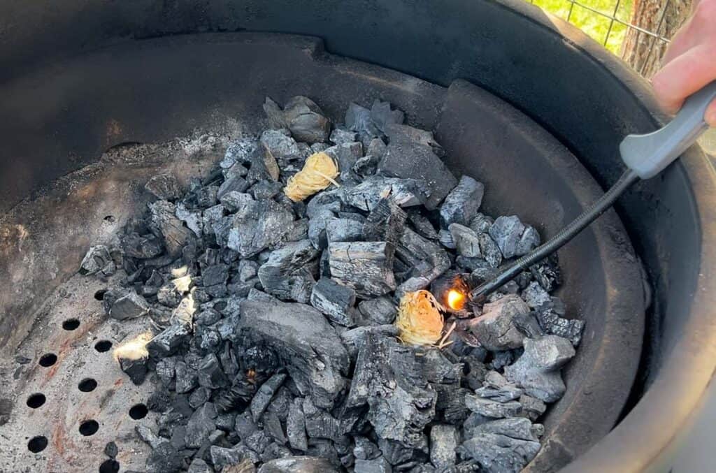 Lighting tumbleweed fire starters with lump charcoal on a Big Green Egg.
