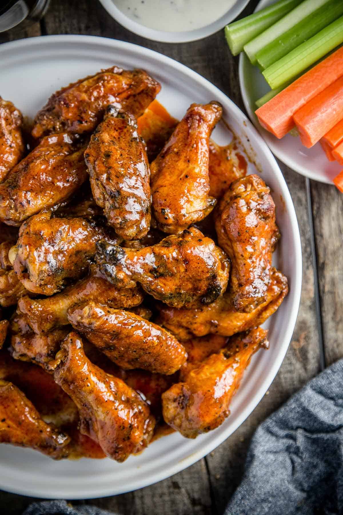 Smoked Buffalo Chicken Wings with crispy skin on a serving platter