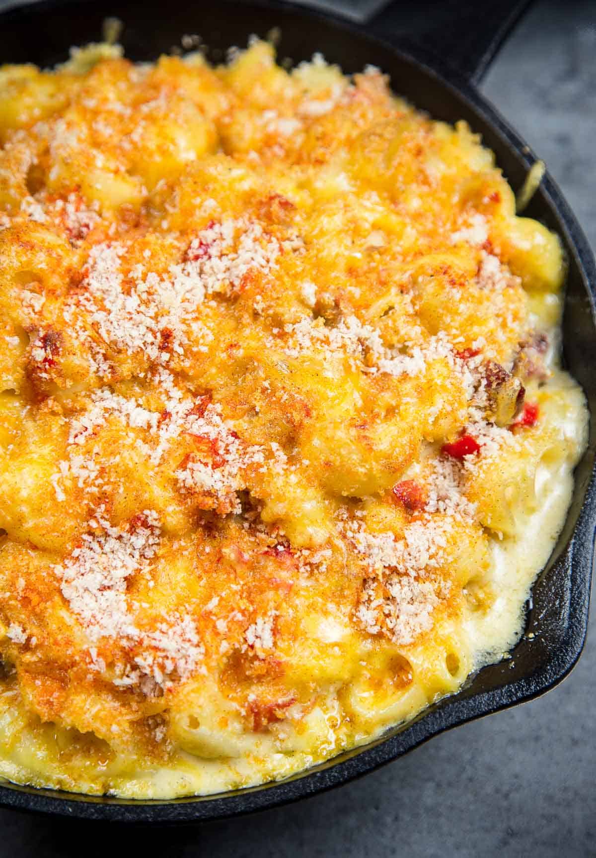 Smoked Tri Tip Mac and Cheese is made with perfectly smoked and tender tri tip, mixed with an ultra creamy cheese sauce and cooked on the grill or in oven. Rich, creamy, smoky, and just perfect. A closeup of Smoked Tri Tip Mac and Cheese in a cast iron pan