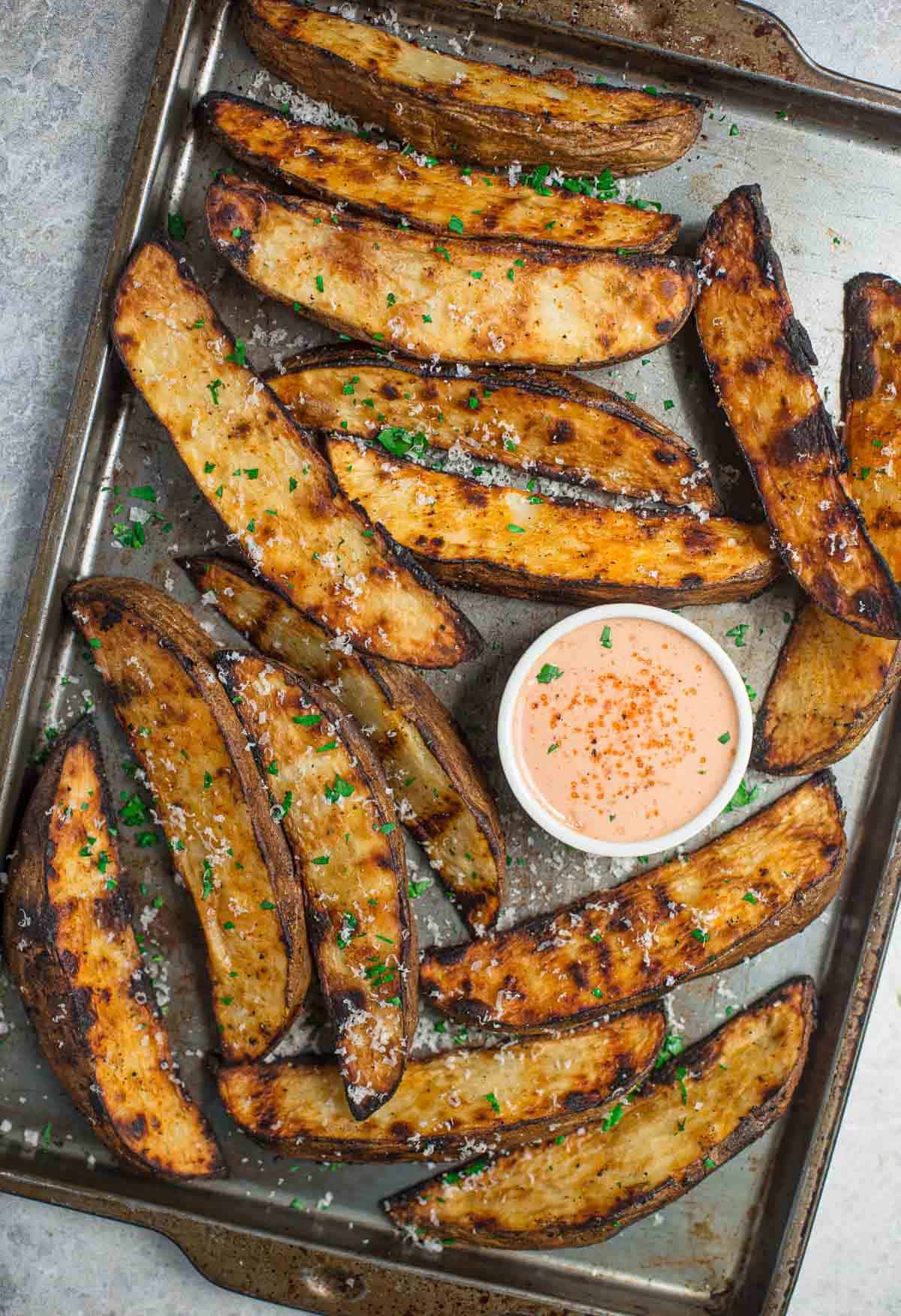 Grilled Potato Wedges with a flavorful fry sauce on a sheet pan