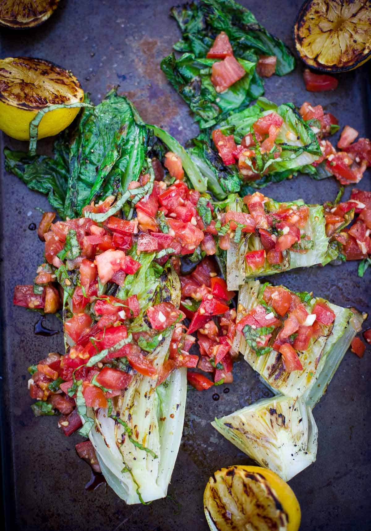 Grilled Romaine Lettuce topped with Tomatoes, Basil, and Balsamic on a serving platter