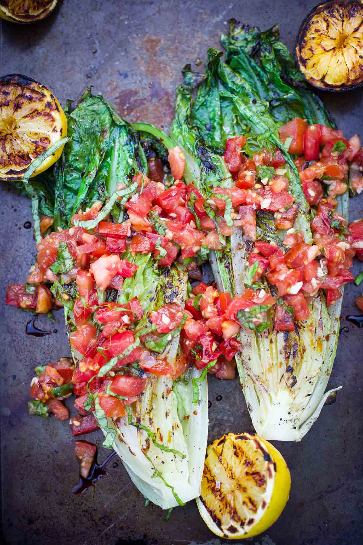 Grilled Romaine Lettuce topped with Tomatoes, Basil, and Balsamic on a serving platter