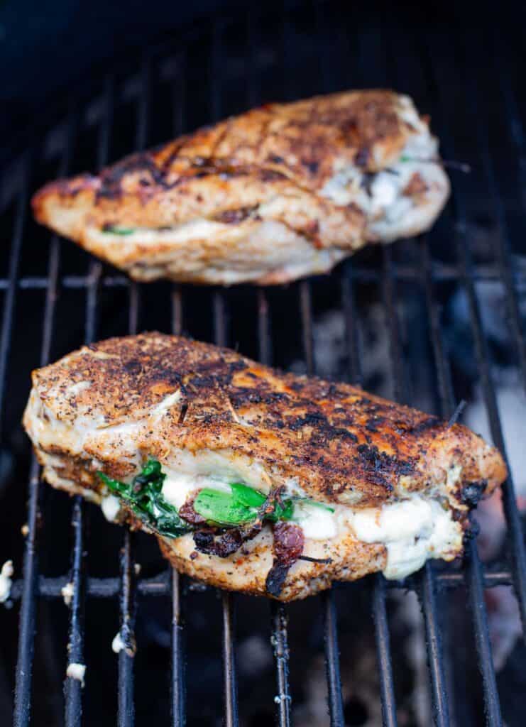 Stuffed Chicken Breasts on a grill cooking 