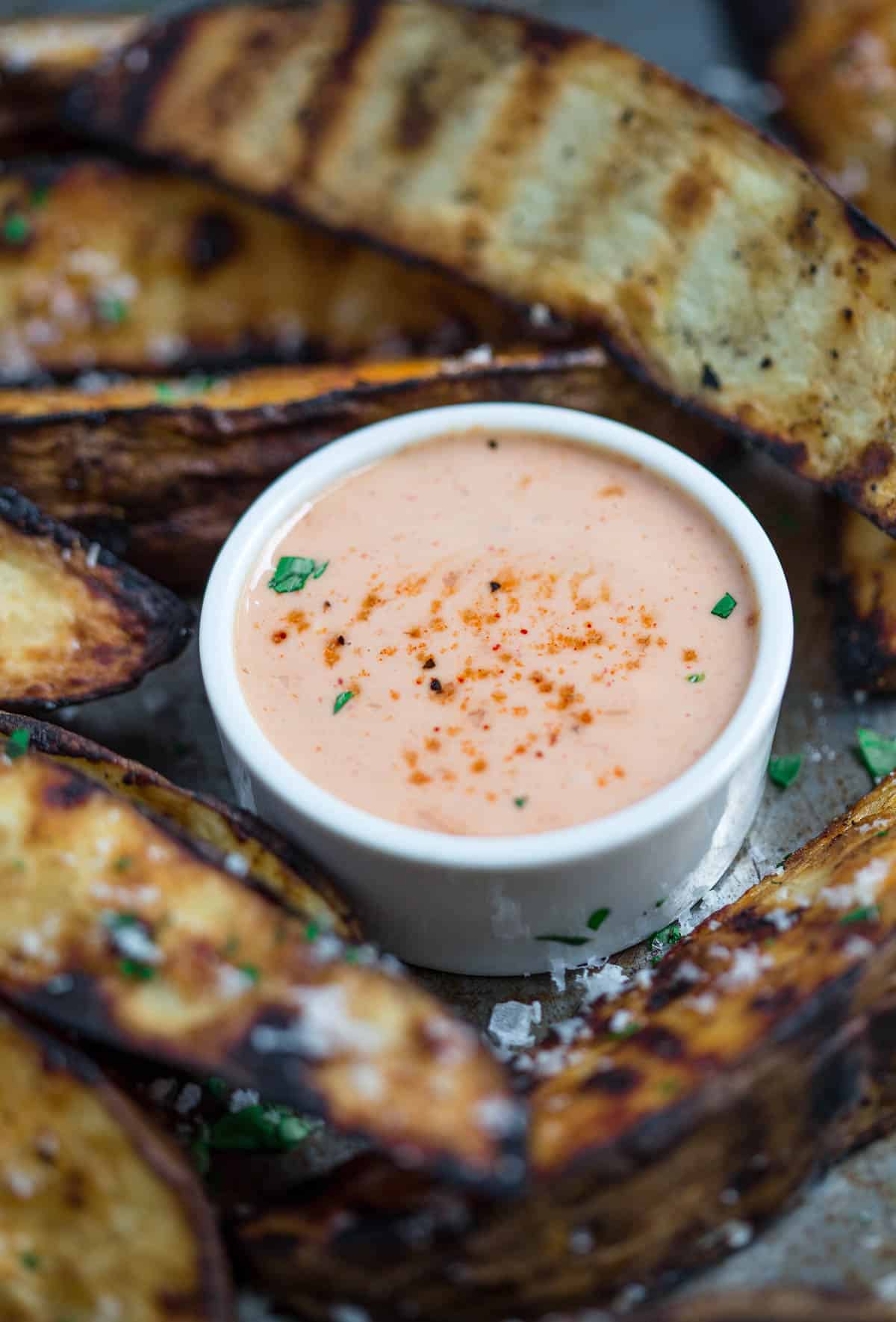 The Ultimate Fry Sauce in a serving bowl surrounded by grilled potato wedges