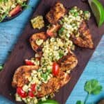Grilled Chicken Breasts topped with a Grilled Corn and Poblano salsa on a serving platter