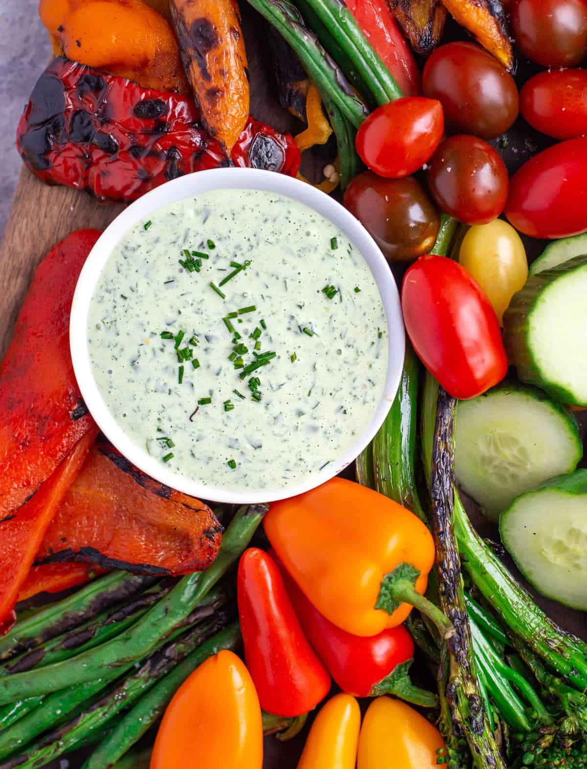 A fresh creamy Tarragon Dip in a bowl surrounded by grilled vegetables