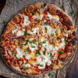 A BBQ Chicken Pizza on a serving platter