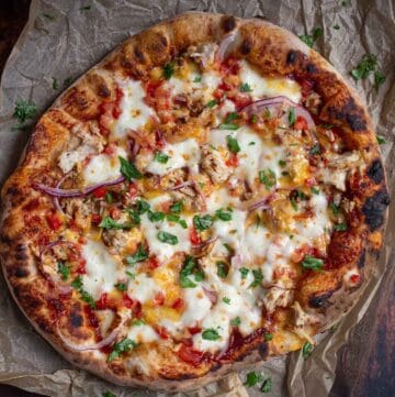 A BBQ Chicken Pizza on a serving platter