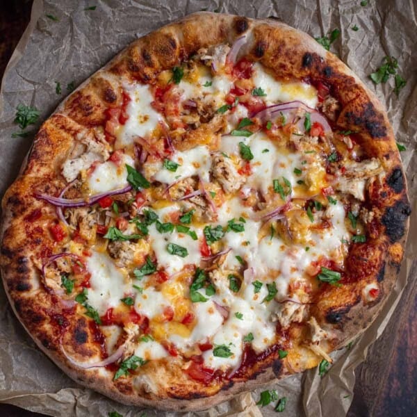 A BBQ Chicken Pizza on a serving platter