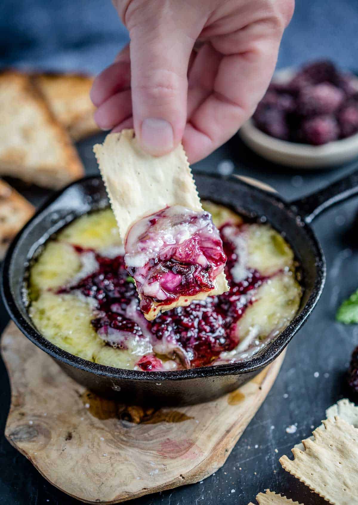 Grilled Baked Brie with Blackberry Jam on a cracker