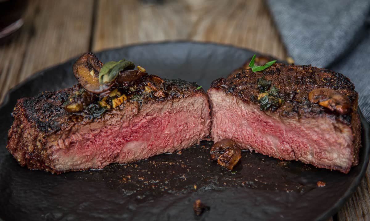 A grilled filet mignon cooked to medium rare, sliced in half