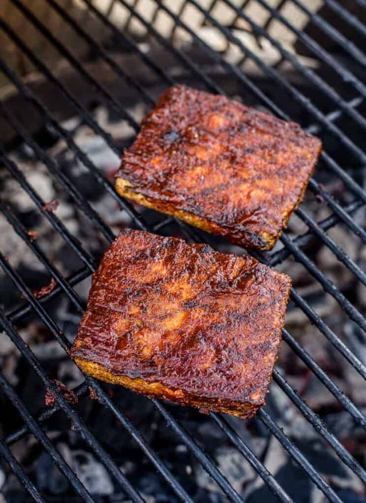 two tofu steaks cooked on the grill and topped with Vindulge red wine bbq sauce