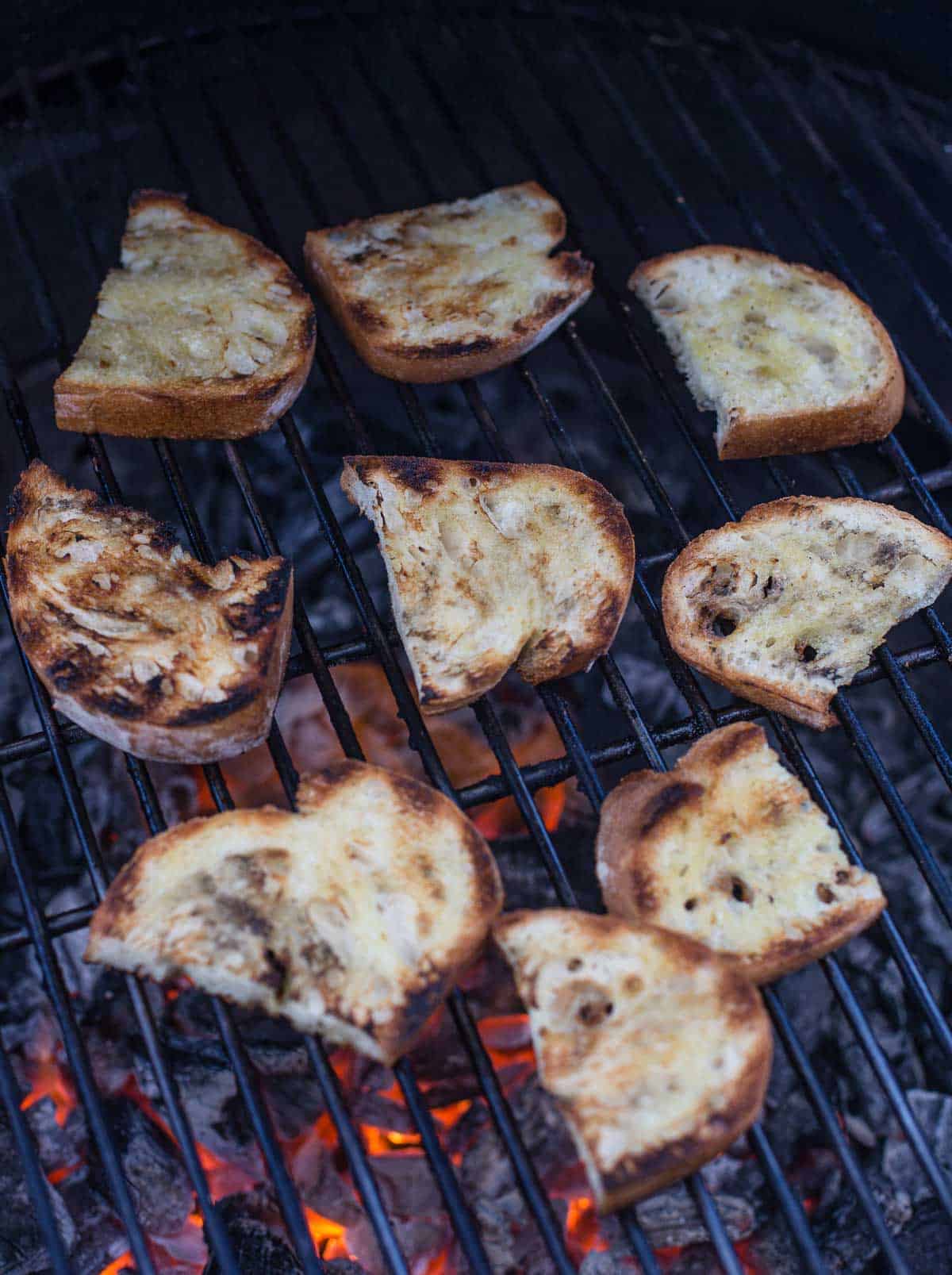 Grilling bread slices over a hot grill