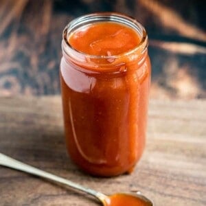 Honey Bourbon BBQ Sauce in a mason jar with a spoon