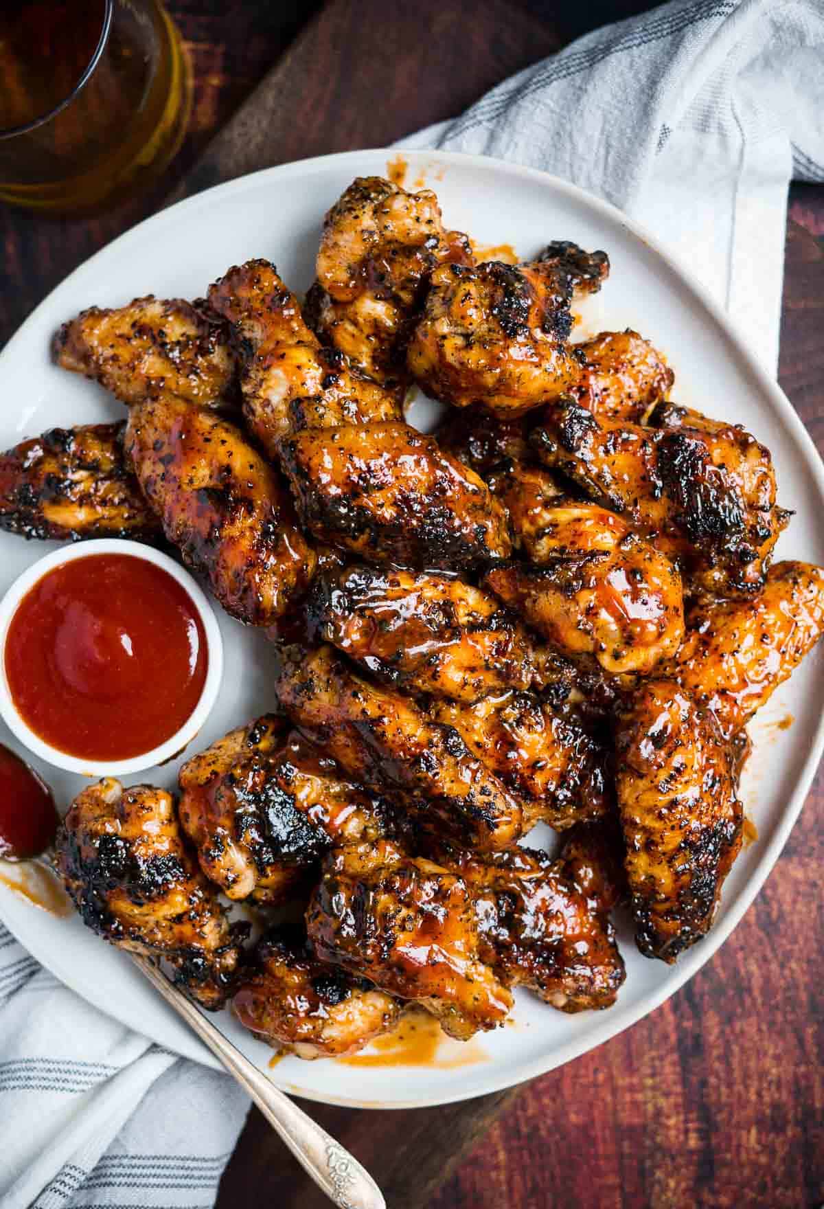 Honey Bourbon Wings on a serving platter with a side of Honey Bourbon BBQ Sauce