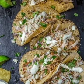 Spicy Grilled Chicken Tacos topped with Avocado Crema on a serving platter