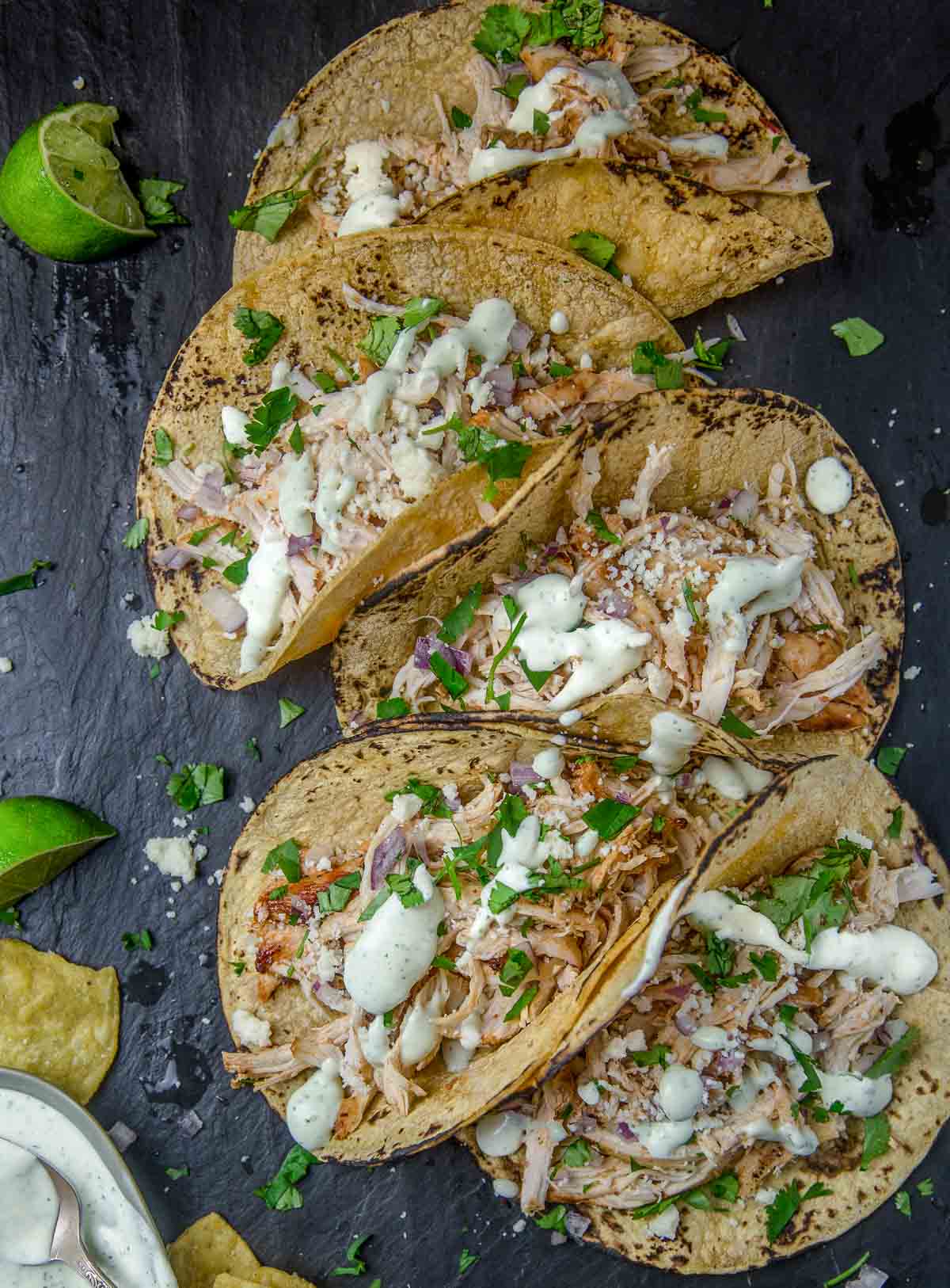 Spicy Grilled Chicken Tacos topped with Avocado Crema on a serving platter