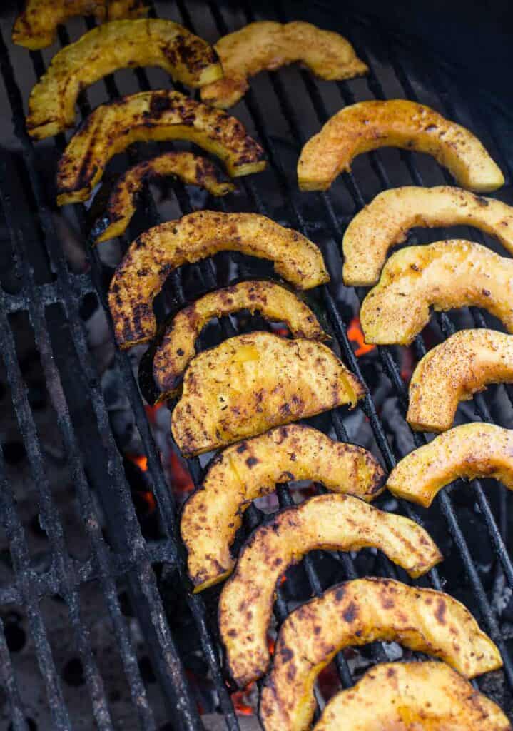 Acorn squash slices over direct heat on a grill