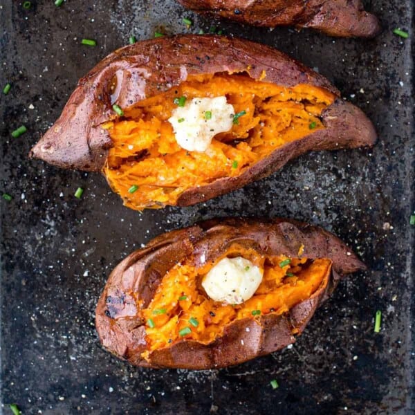 Grilled Baked Sweet Potatoes on a sheet pan topped with smoked honey butter