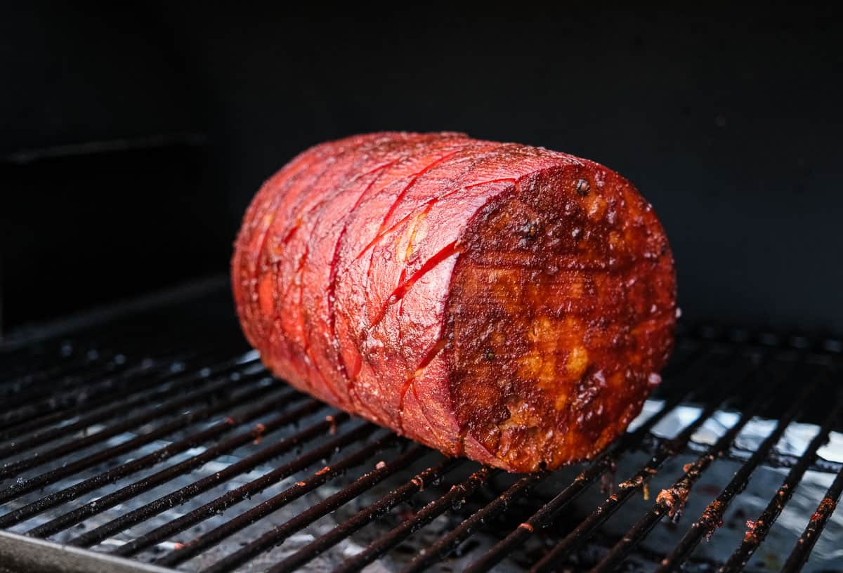 A whole Mortadella smoking on a pellet grill