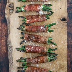 Grilled Prosciutto wrapped Green Bean bundles on a serving platter