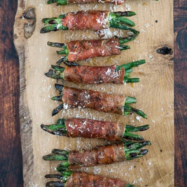 Grilled Prosciutto wrapped Green Bean bundles on a serving platter