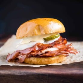 A fried mortadella sandwich on a cutting board