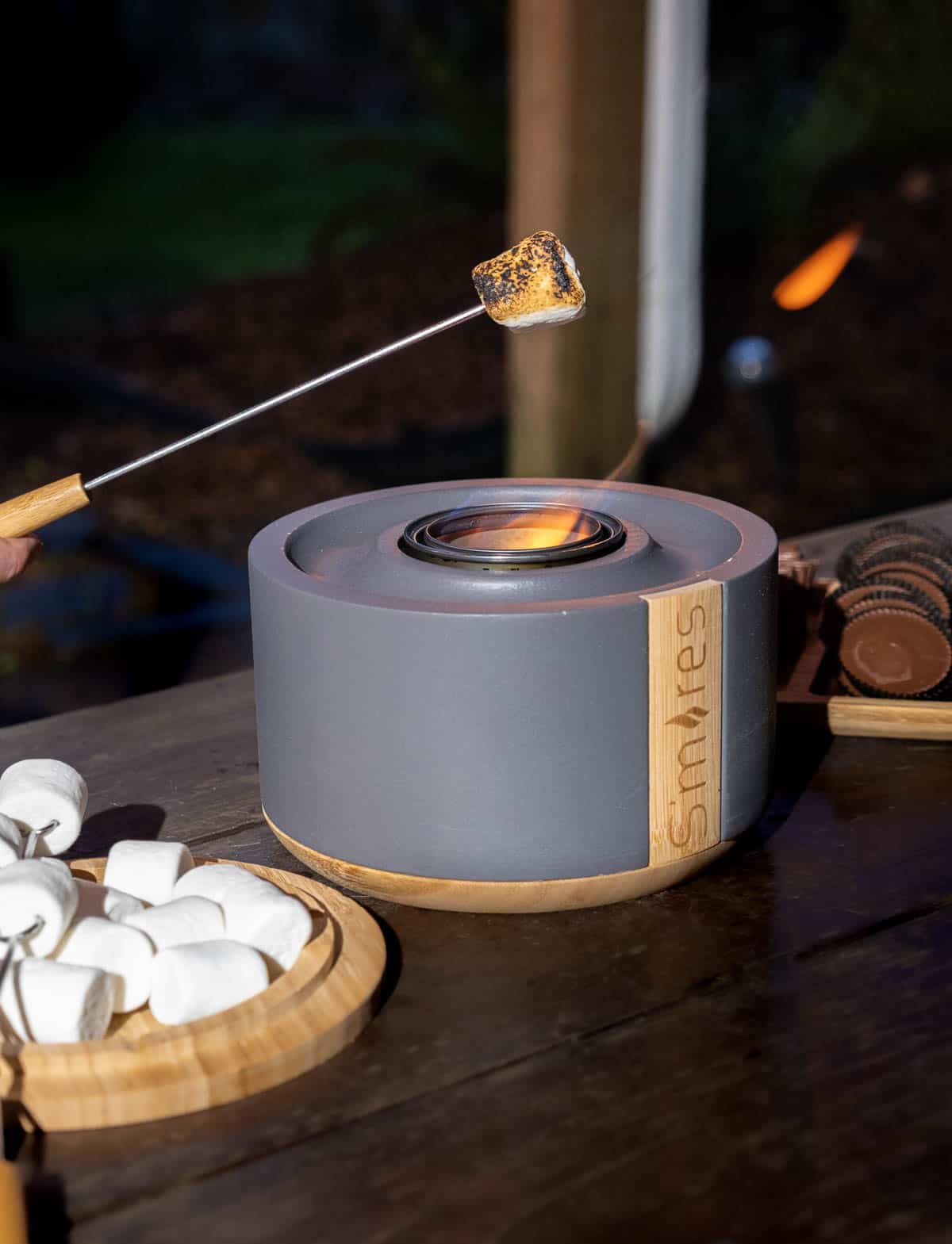 Terraflame S'mores kit with flame going and marshmallow being cooked.