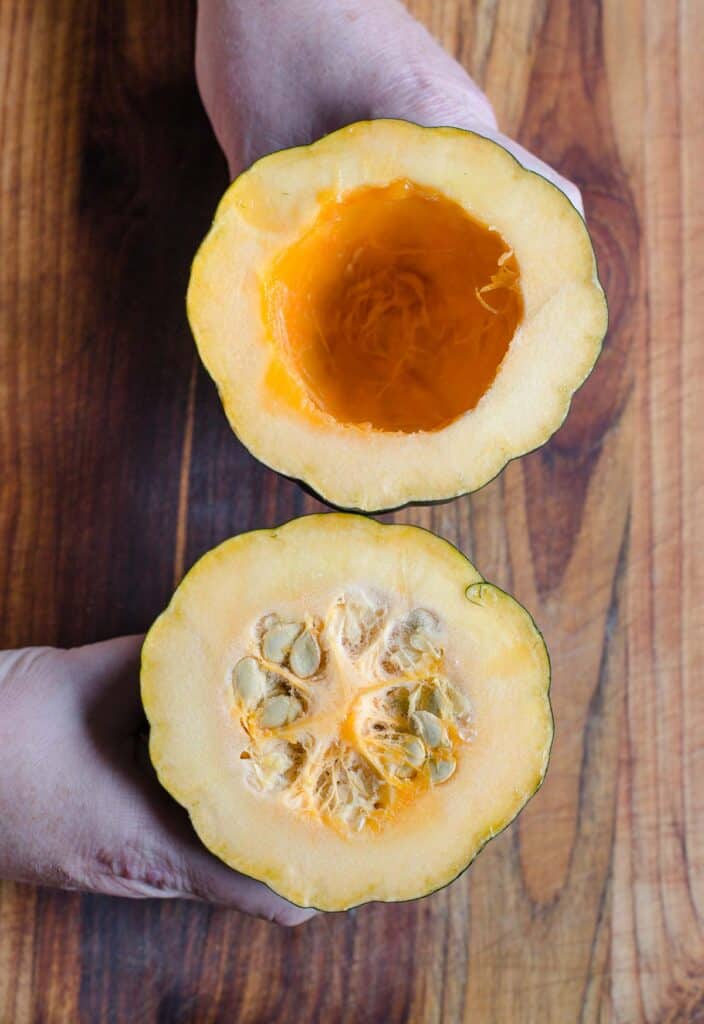 Acorn squash sliced in half showing the flesh inside