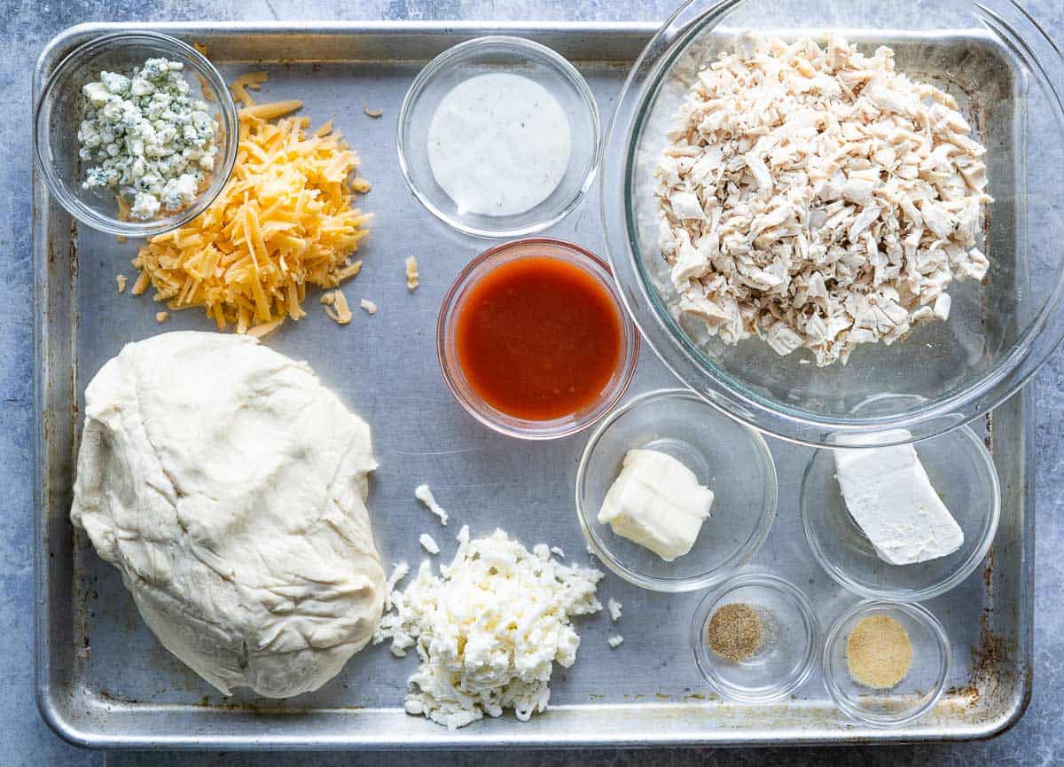 Ingredients for Buffalo Chicken Pull Apart Bread on a sheet pan